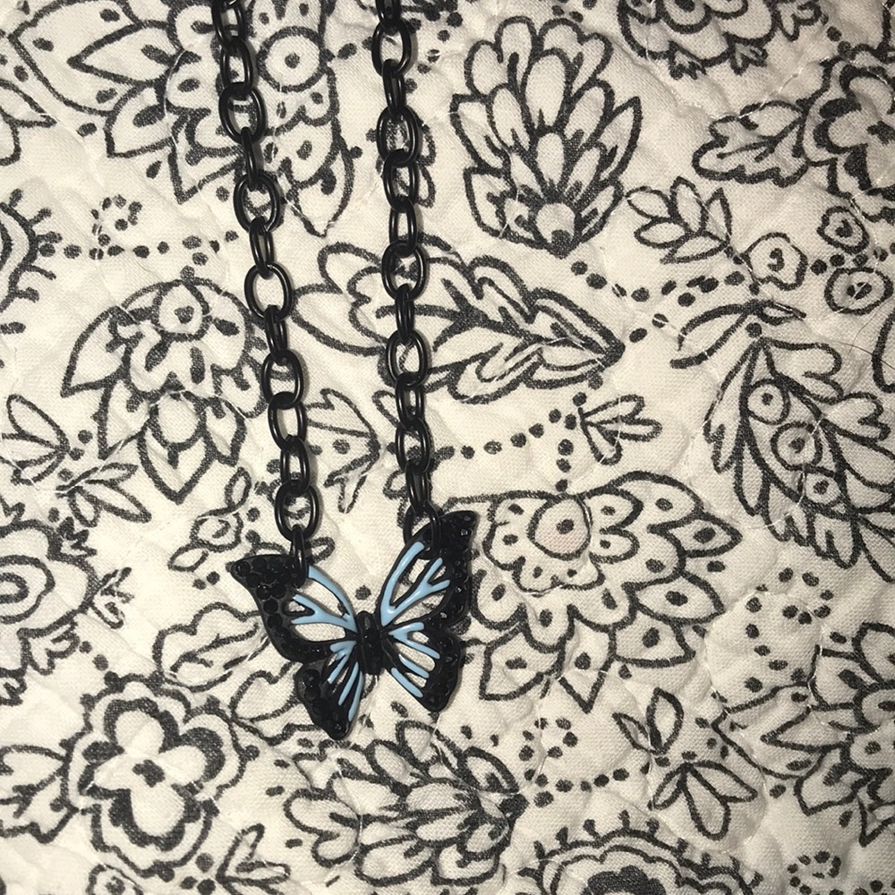 Blue butterfly necklace on gunmetal chain